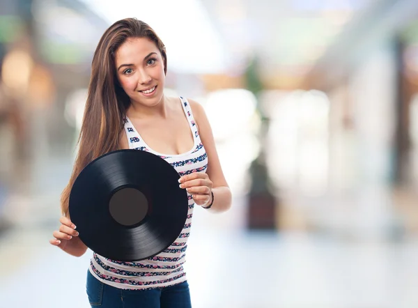 Mulher segurando um vinil — Fotografia de Stock