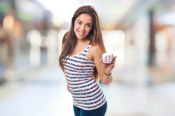 Chica bonita sosteniendo un dado — Foto de Stock