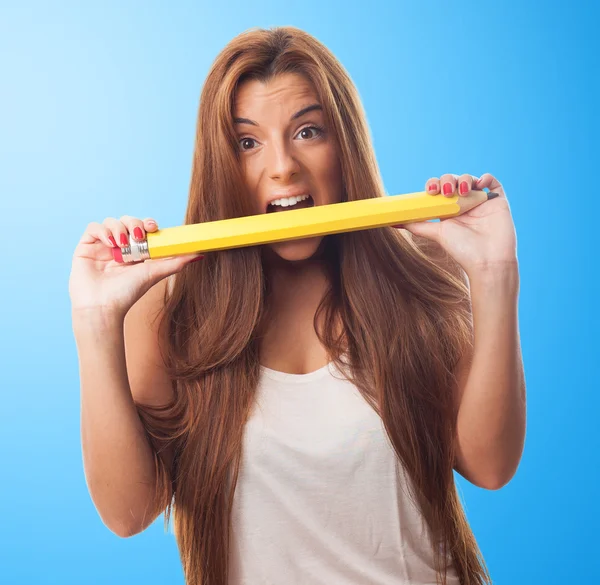 Woman biting a big pencil — Stock Photo, Image