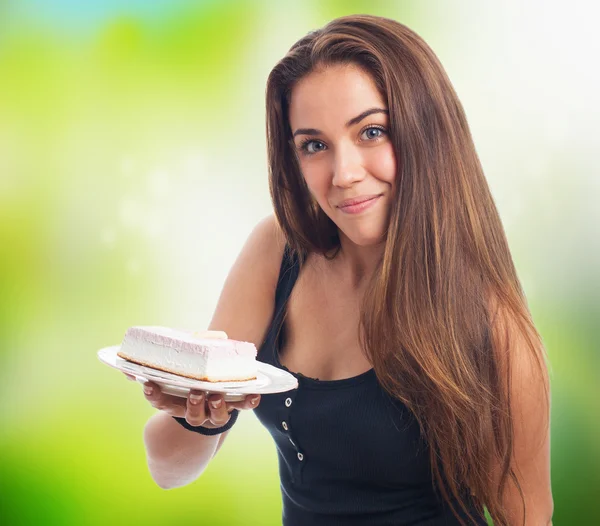 Woman holding a dish with a cake — Stock Photo, Image