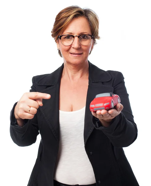 Woman holding car — Stock Photo, Image