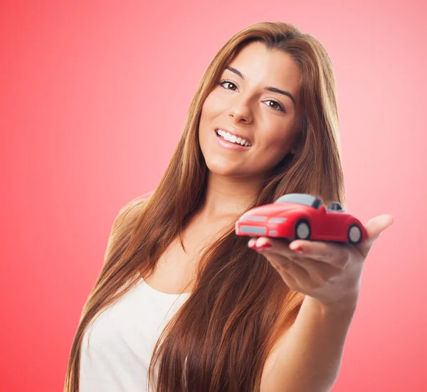 Mulher segurando um brinquedo de carro — Fotografia de Stock