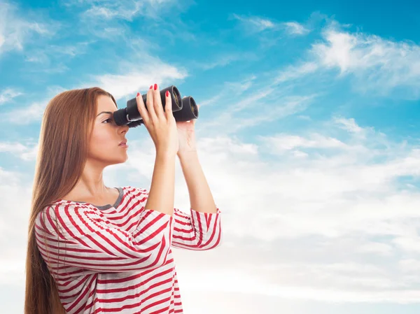 Woman looking through the binoculars — Stock Photo, Image