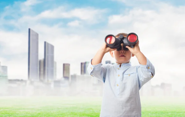 Boy looking through the binoculars — Stock Photo, Image