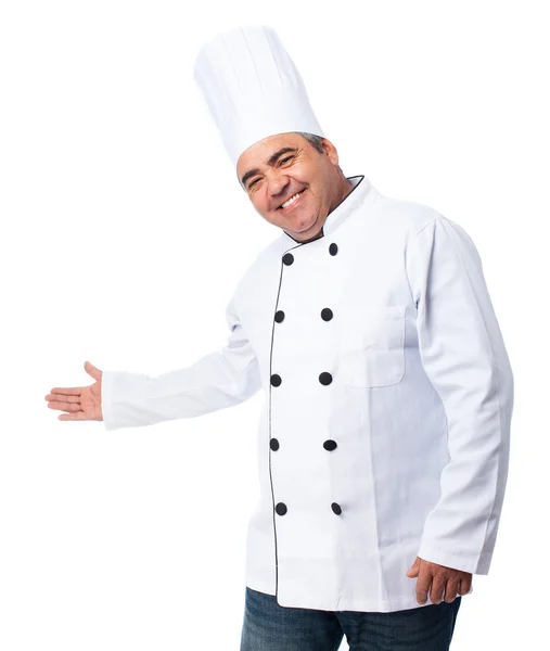 Cook man doing a welcome gesture — Stock Photo, Image