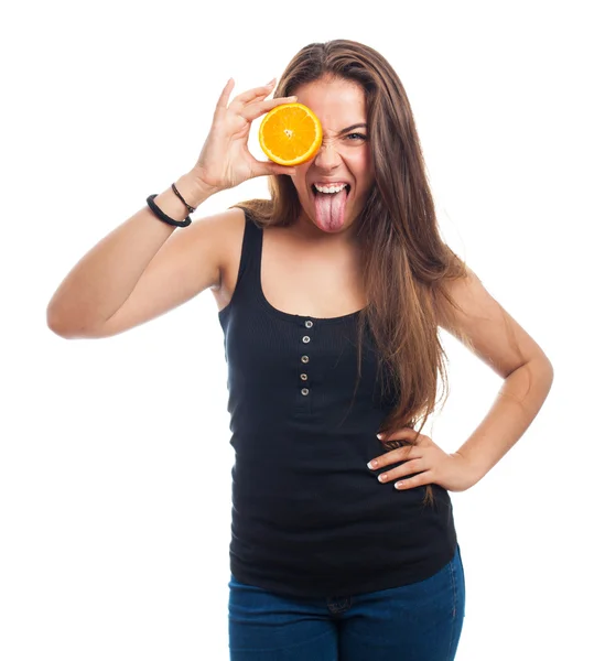 Woman holding an orange slice joking — Stock Photo, Image