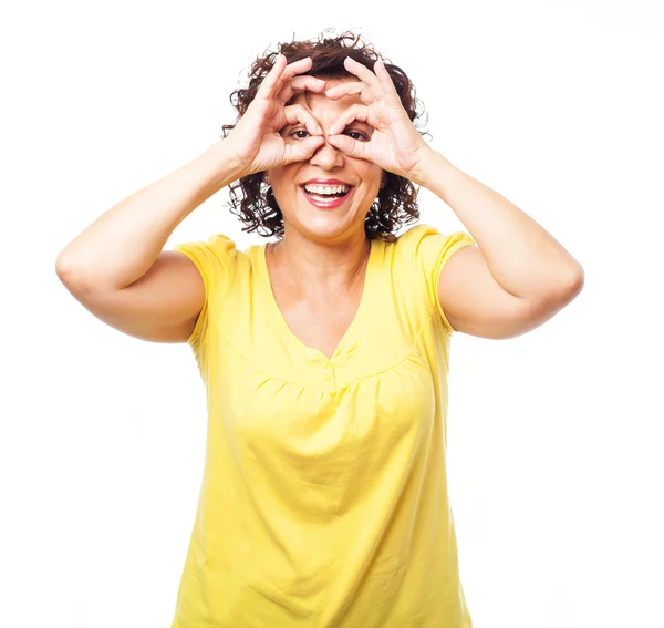 Mature woman doing a glasses symbol — Stock Photo, Image