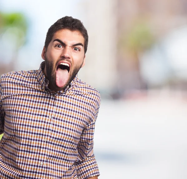 Homme montrant sa langue — Photo