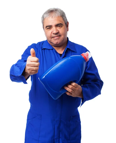 Mechanic holding an oil bottle — Stock Photo, Image