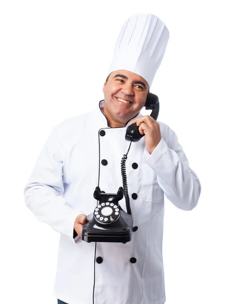 Cook man talking by telephone — Stock Photo, Image