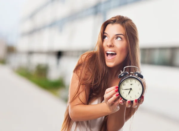 Pretty woman holding a clock — Stock Photo, Image