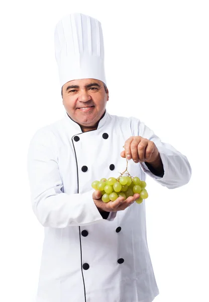 Cook man holding  grapes — Stock Photo, Image