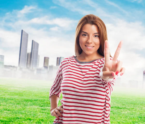 Woman doing a victory symbol — Stock Photo, Image