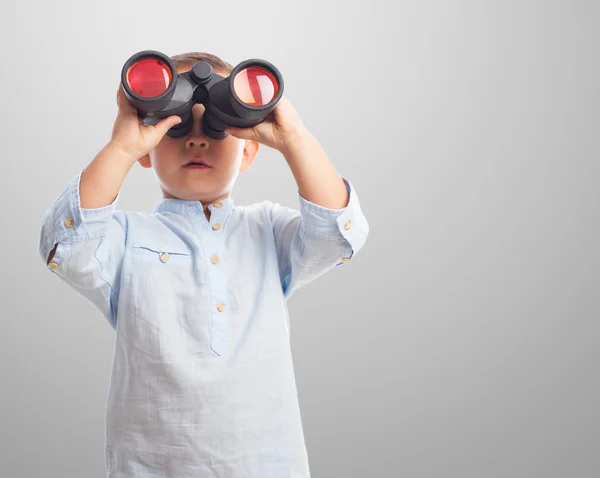 Boy looking through the binoculars — Stock Photo, Image