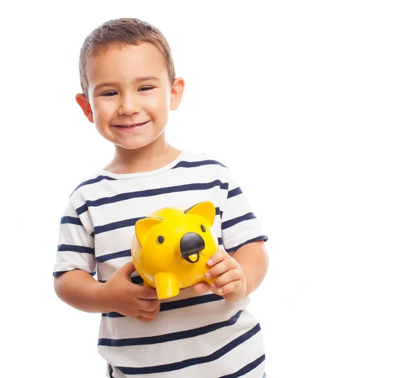 男孩抱着一个存钱罐 — 图库照片