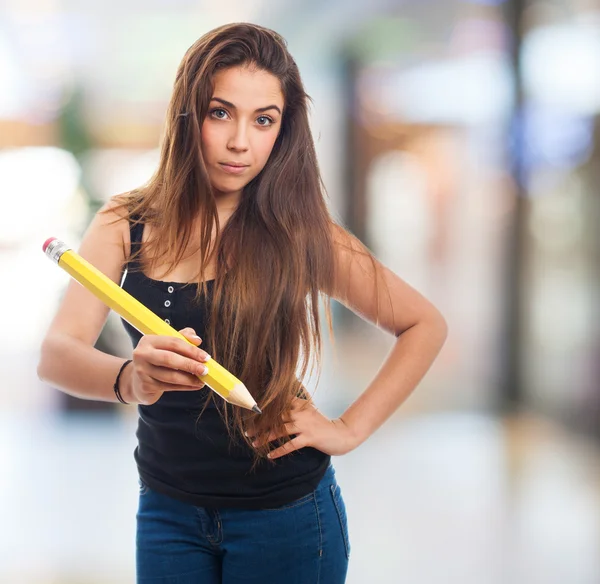 Student holding a big pencil — Stock Photo, Image