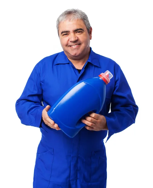 Mechanic holding an oil bottle — Stock Photo, Image