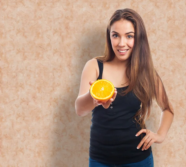 Woman holding an orange slice Royalty Free Stock Photos