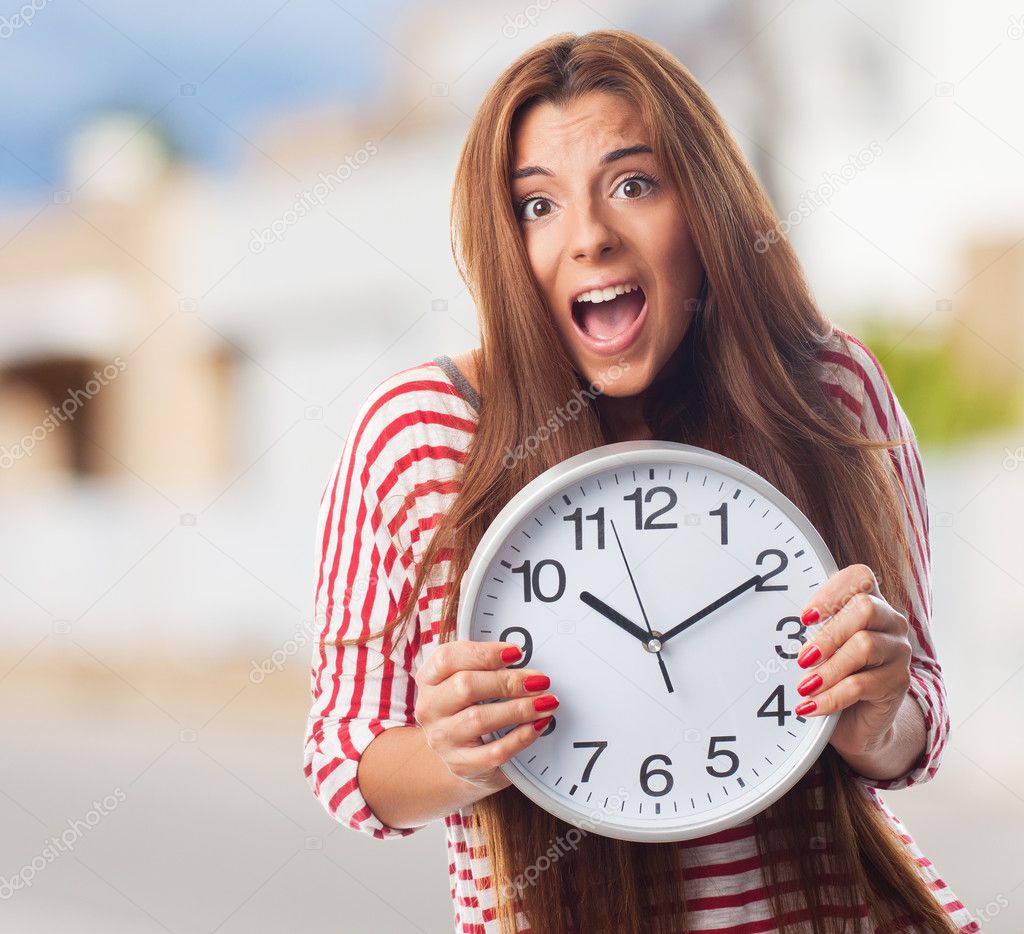 woman holding a big clock