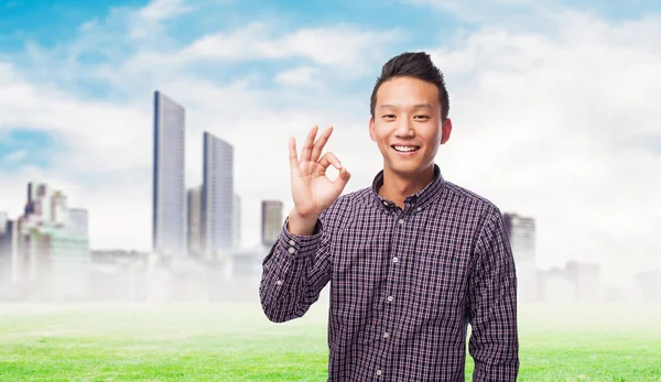 Asian man doing the okay gesture — Stock Photo, Image