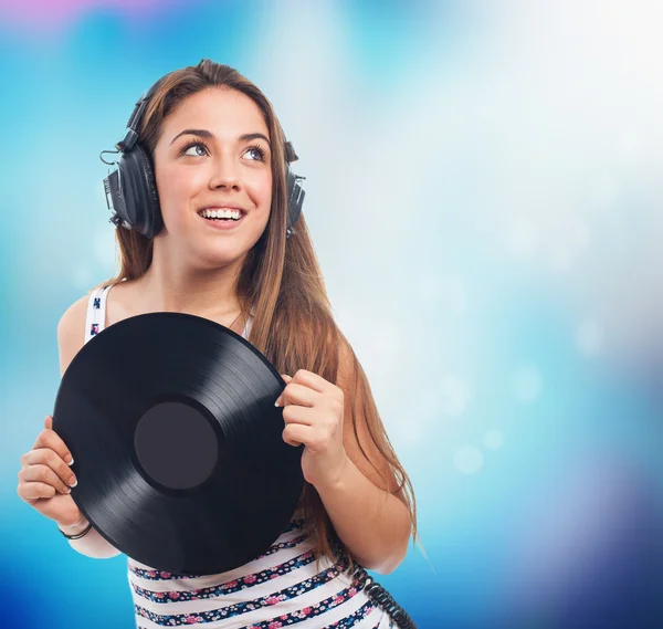 Girl holding a vinyl listening to music — Stock Photo, Image