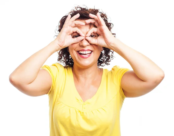 Mature woman doing a glasses symbol — Stock Photo, Image