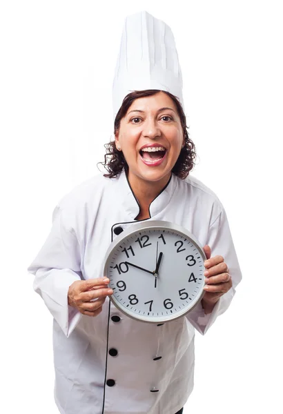 Cook woman holding a big clock — Stock Photo, Image