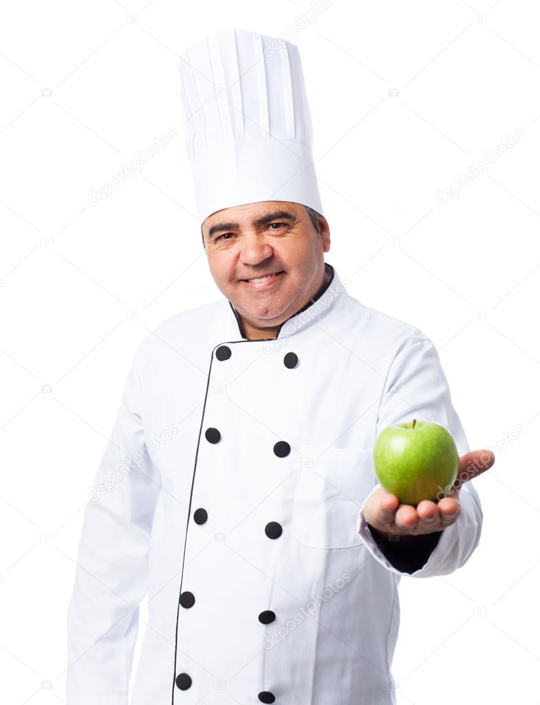 Cook man holding  apple