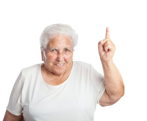Old woman pointing up with finger — Stock Photo, Image