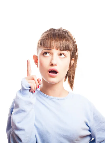 Surprised girl pointing up — Stock Photo, Image