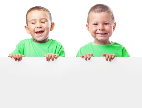 Children behind a billboard — Stock Photo, Image