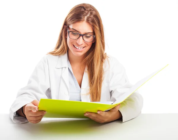 Doctor reading a medical report — Stock Photo, Image