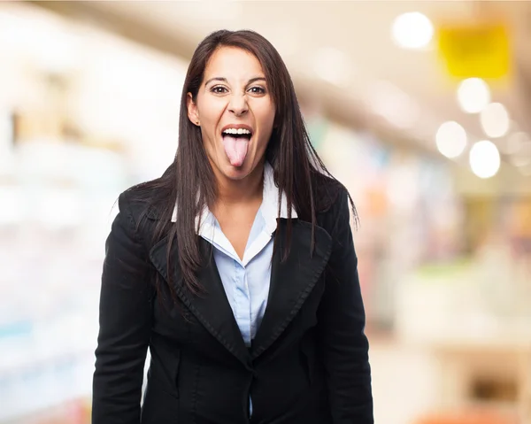 Business woman showing tongue — Stock Photo, Image