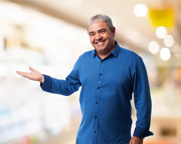 Mature man holding something — Stock Photo, Image