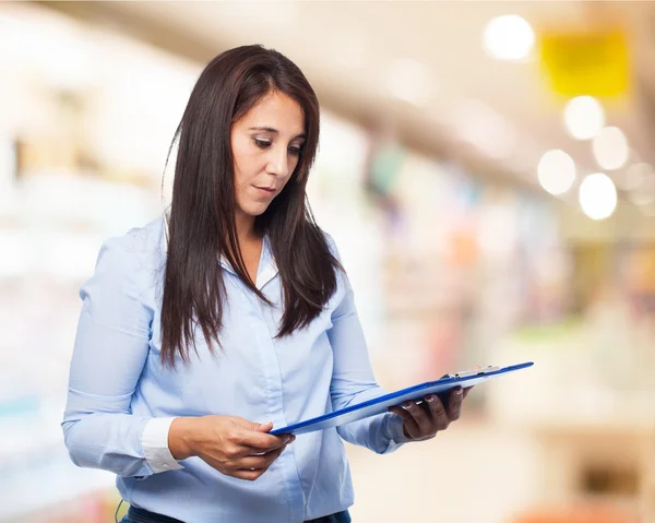 Woman holding inventory — Stock Photo, Image