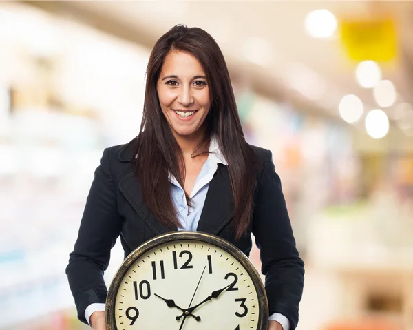 Cool businesswoman with clock — Stock Photo, Image