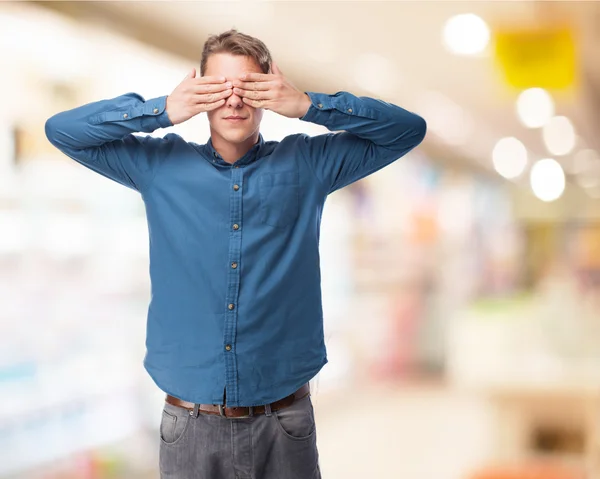 Young man covering eyes — Stock Photo, Image