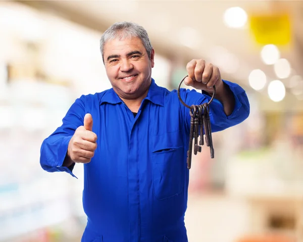 Locksmith holding old keys bunch — Stock Photo, Image