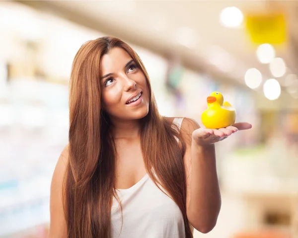 Woman smiling and holding duck toy — Stock Photo, Image