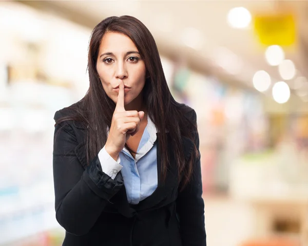 Businesswoman showing silence sign — Stock Photo, Image