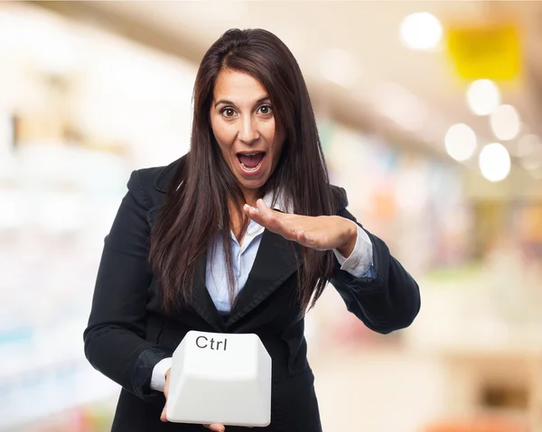 Businesswoman with control key — Stock Photo, Image