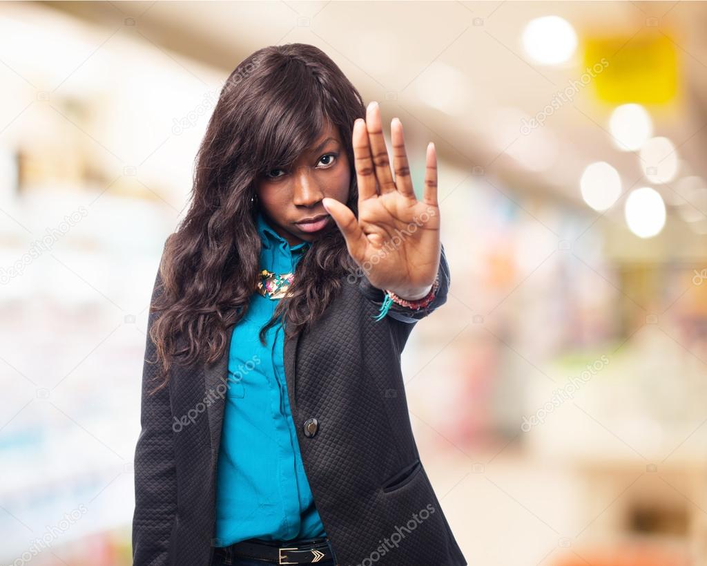 Black woman shows stop gesture