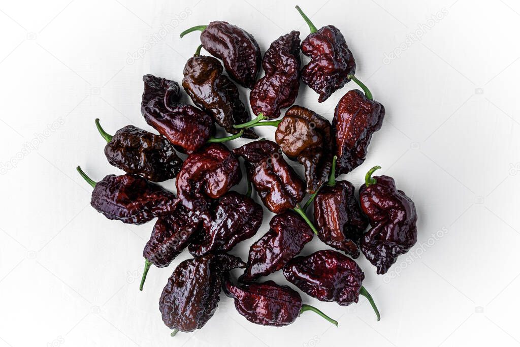 Photograph of Chocolate Carolina Reaper Peppers on White Background