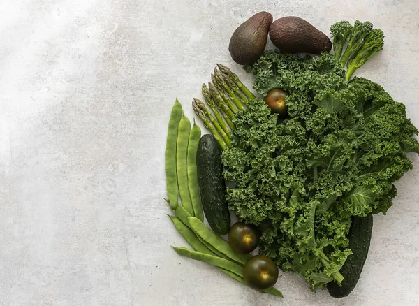 Green vegetables and leafy food background. Healthy eating green concept of fresh organic products. Top view, copy space.