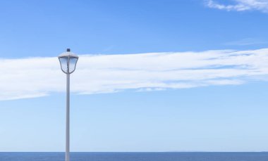 Arka planda güzel bir gökyüzü ve deniz olan ışık fenerinin güzel bir görüntüsü..