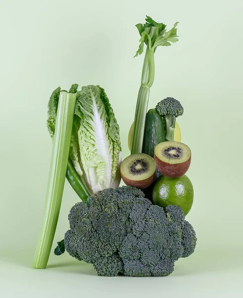 Fresh green vegetables and fruits on green background. Equilibrium floating food balance. — Stock Photo, Image