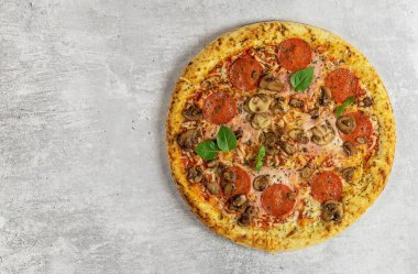 Mantarlı, jambonlu, domatesli, peynirli taze İtalyan pizzası. Fast food teslimatı. Tarif ve menü için alanı kopyala. 
