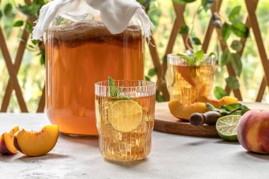 Kombucha tea slightly alcoholic, lightly effervescent drink with peach and lime.  clipart