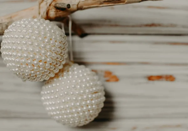 White Christmas balls hang on a branch. Christmas tree decoration. Holiday concept