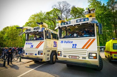 BRÜKSEL, BELGIUM - Mayıs 12021 - Covid-19 kısıtlamalarına karşı Brüksel Bois de la Cambre Parkı 'nda gezginler. Polis, La Boum adlı bir etkinlikte insanları dağıtmak için atlar, göz yaşartıcı gaz ve su topu kullandı.